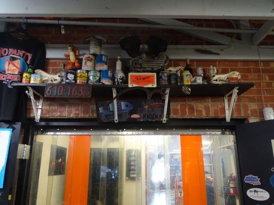 CONTENT OF SHELF 45 FLATHEAD MOTOR PARTS, OIL CANS, SKULLS, LARGE SPARK PLUG, WINE & GLASSES