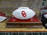 OU FOOTBALL SIGNED BY BILLY SIMS, STEVE OWENS & JASON WHITE IN A CASE