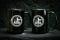 2 black FCA mugs
