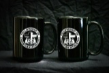 2 black FCA mugs