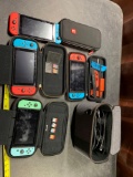 4 NINTENDO SWITCHES WITH CASE AND 5 GAMES