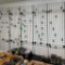 5- 2'x7' Gridwall Panels, Inlcudes Wall Mount Brackets and Peg Hooks Hanging on them