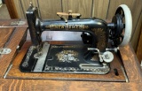 Antique New Home sewing machine in English Oak Case