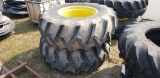 pair of 18.4-26 tires on rims of JD 4420 combine