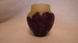 Green vase overlaid with purple/brow flowers, marked Salli” on side, 2.75”H x 2.5”W