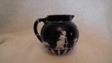 Dark blue & white creamer, woman & animal design, a few stray blue paint dots on bottom, 3/5”H x 4”W