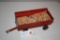 red wagon with grain and shovel