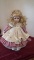 Blonde girl doll with flowers in hair, pink dress with cream overlay, porce