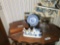 Items on top of Wooden Table Inc. Oil Lamp