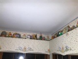 Pooh Items & more on shelf around ceiling