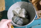 Galvanized Bucket full of Old Insulators