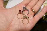 3 gold rings set with stones.