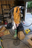 Ext cord, weed whacker on metal stand
