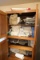 Cupboard of assorted linens, etc