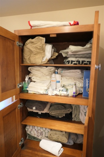 Cupboard of assorted linens, etc