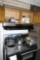 Items on top of stove and in cupboard - cookware