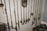 Large lot of fishing reels and poles.