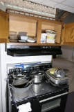 Items on top of stove and in cupboard - cookware