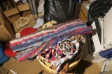 Bundle of woven rugs or mats in basket