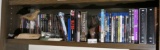 Shelf lot of DVDs, carved bird etc.