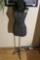 Dress form on stand with steampunk hat, goggles