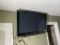 Flat screen TV on wall with remote