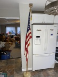 Flag on tall flagpole stand with eagle topper