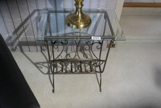 Glass topped table with fancy metal base