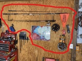 Fishing Poles, reel, assorted fishing related on wall