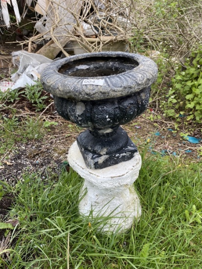 Plastic flower urn on cement base