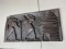 Old African Carved Plaque Figures entering a shelter