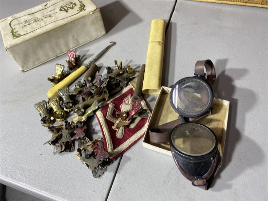 Old goggles, button hook, patch, metal clips, candy box