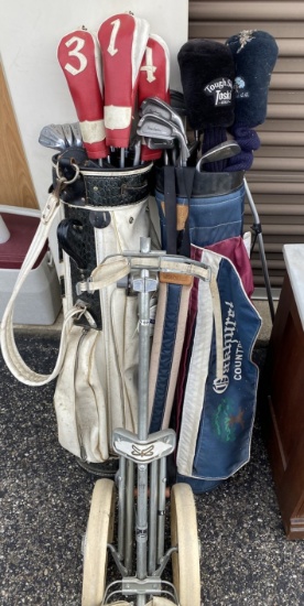 Two sets of old golf clubs plus club dolly