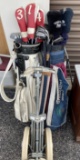 Two sets of old golf clubs plus club dolly