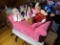 Group lot of dolls on miniature couch