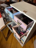 Cabinet with drawers full of barbie accessories