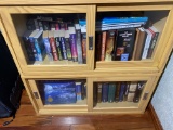 Assorted books in cabinet