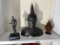 Metal statue of a man, buddha statue, small jar