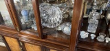 Shelf lot of assorted glass and more in cabinet