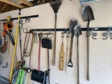 Large lot of hand tools along wall