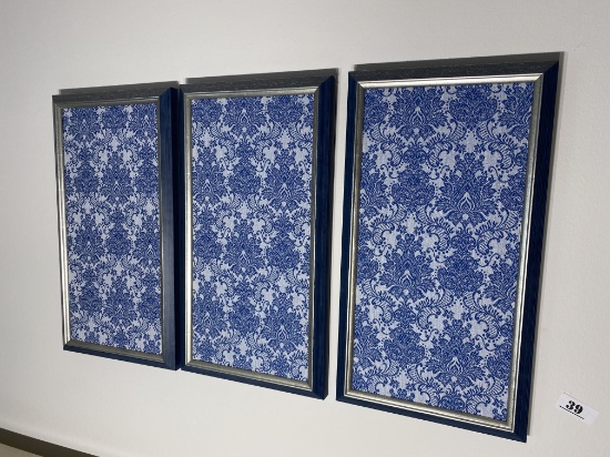 Three framed blue and white fabric pieces