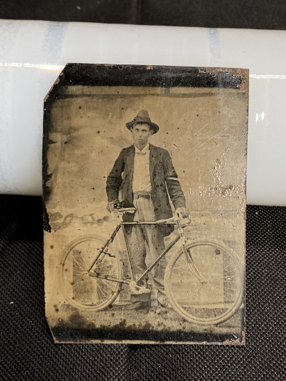 Early tintype of a man with Bicycle