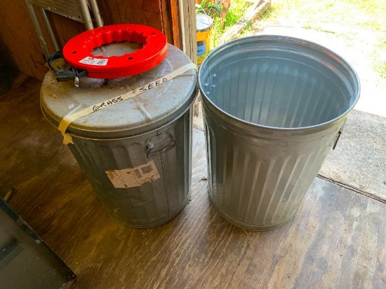 2 Galvanized Trash Cans & Steel Tape.  One can has bags of grass seed.