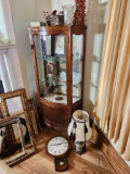 Curio Cabinet with Contents, Wall Clock, and Ceramic Lamp with Shade