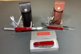 Three Vintage Victorinox Officer Suisse, Swiss Army Knives, One in Original Box; Two Leather Sheaths