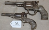 2 ornate iron cap guns, 