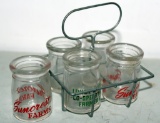 5 individual glass creamers with metal holder --