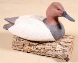 D.R.D marked canvasback decoy on log