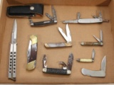 Flat lot containing 9 folding blade pocket knives.