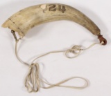 Scrimshawed shell embellished powder horn with brass spout and leather hanger.